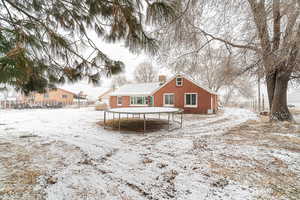 View of snow covered rear of property