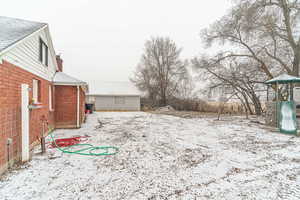 Yard covered in snow with a playground