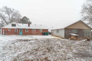 View of snow covered rear of property