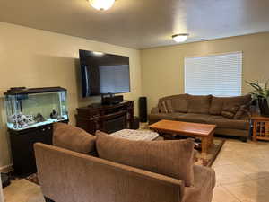 Tiled living room with a textured ceiling