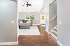 Interior space featuring ceiling fan, lofted ceiling, and dark hardwood / wood-style flooring