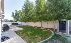 View of yard featuring a shed and a patio area