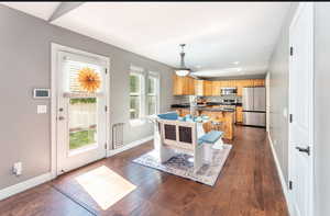 Dining room with dark hardwood / wood-style flooring