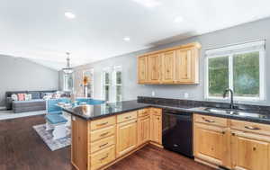 Kitchen featuring pendant lighting, sink, kitchen peninsula, and dishwasher