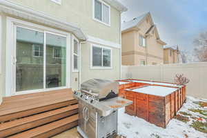 Snow covered patio with area for grilling