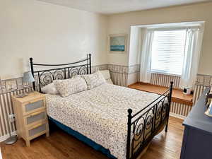 Bedroom with wood-type flooring