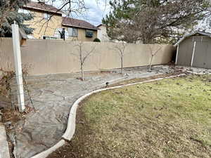 View of yard with a storage unit