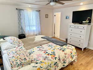 Bedroom featuring ceiling fan and light hardwood / wood-style floors