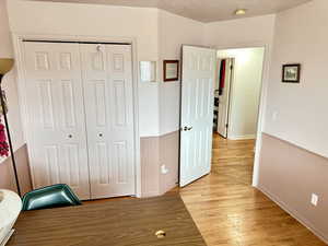 Unfurnished bedroom with light hardwood / wood-style floors and a closet