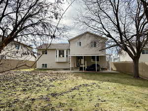 Back of house featuring a yard and a patio area