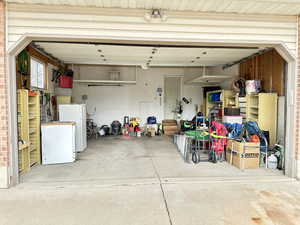 Garage featuring white refrigerator