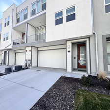 View of front of home with central AC and a garage