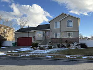 View of front facade featuring a garage