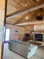 Living room featuring beamed ceiling and wooden ceiling