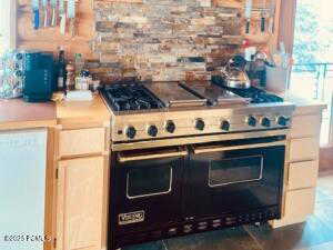 Kitchen featuring range with two ovens and dishwasher