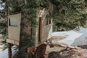 Snow covered structure featuring an outdoor structure