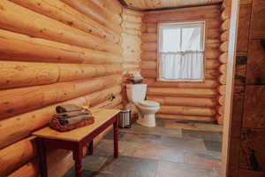 Bathroom featuring toilet and wood ceiling