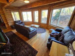 Living room featuring rustic walls and hardwood / wood-style floors