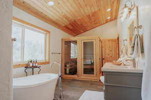 Full bath with recessed lighting, a soaking tub, vaulted ceiling, and wood ceiling