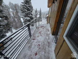 View of snow covered back of property