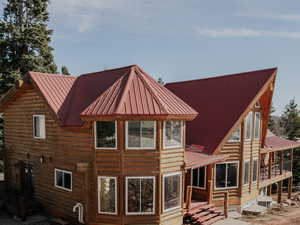 Rear view of house featuring metal roof