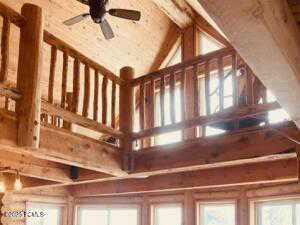 Details featuring beamed ceiling, wooden ceiling, and ceiling fan