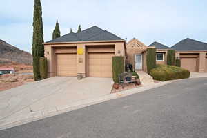 View of front of house with a mountain view, a garage