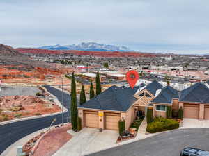 View of front of home featuring stucco siding, central air condition unit, concrete driveway, an attached garage, and a mountain view