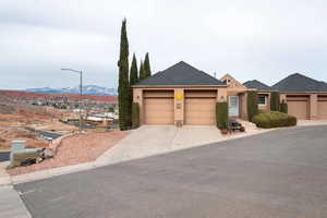 View of front of house with a garage and a mountain view