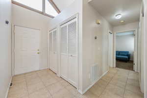 Corridor featuring light tile patterned flooring