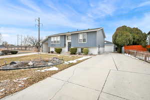 View of front of property with an outbuilding and a garage