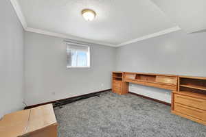 Bedroom featuring ornamental molding, light colored carpet, and a textured ceiling