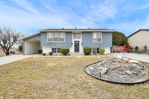 Split foyer home with a carport and a front yard