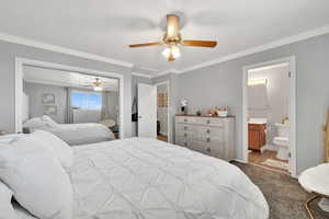 Carpeted bedroom with ornamental molding, a textured ceiling, ceiling fan, and a closet