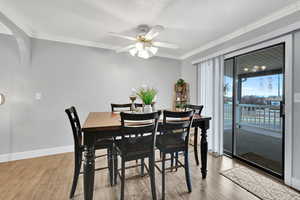 Dining room featuring ornamental molding, ceiling fan, a textured ceiling, and light wood-type flooring