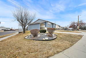 View of side of home featuring a yard