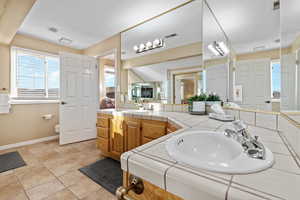 Bathroom featuring vanity, toilet, and tile patterned flooring