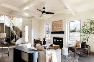 Living room with coffered ceiling, wood-type flooring, and plenty of natural light