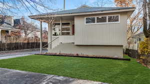 View of front of house featuring a front lawn..grass edited to appear greener