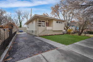 View of front of property featuring a front yard with grass edited