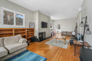 Living room featuring parquet floors and a brick fireplace