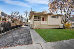 View of front facade featuring a front lawn with grass edited