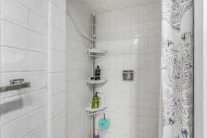 Bathroom featuring a shower with shower curtain