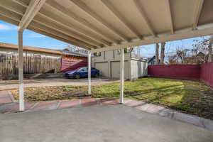 View of patio with a shed