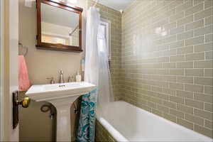 Bathroom featuring shower / bath combination with curtain