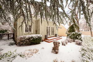 View of snow covered rear of property