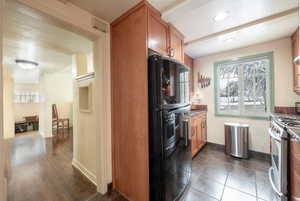 Kitchen featuring dark hardwood / wood-style floors and stainless steel range oven