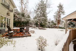 Snowy yard with an outdoor fire pit