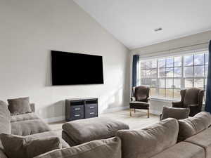 Family room featuring lofted ceiling and light hardwood / wood-style flooring