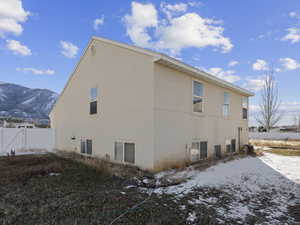 View of snow covered exterior featuring a mountain view